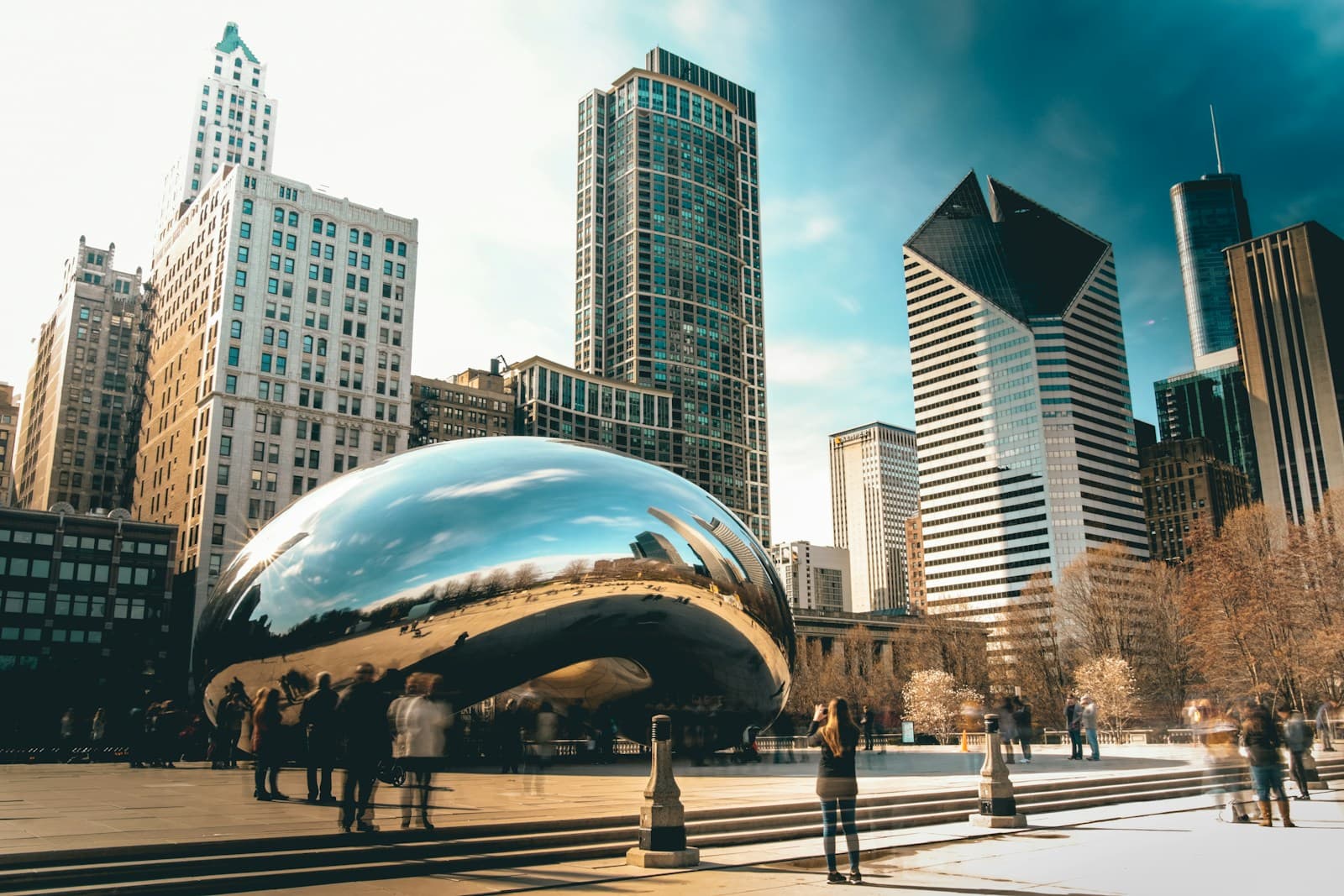Cloud Gate stainless steel sculpture reflecting Chicago skyscrapers in Millennium Park