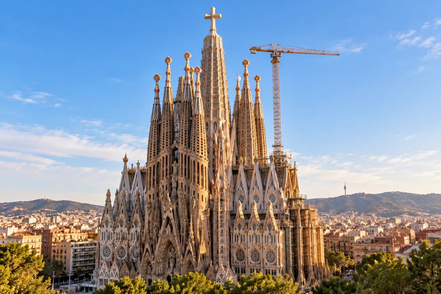 Sagrada Família in Barcelona with construction crane beside its completed central towers in 2026.
